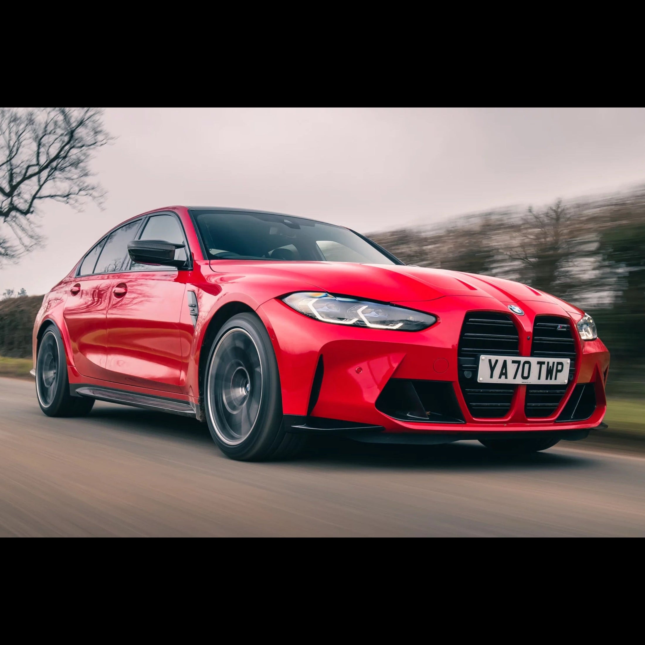 a red BMW M3 Driving fast