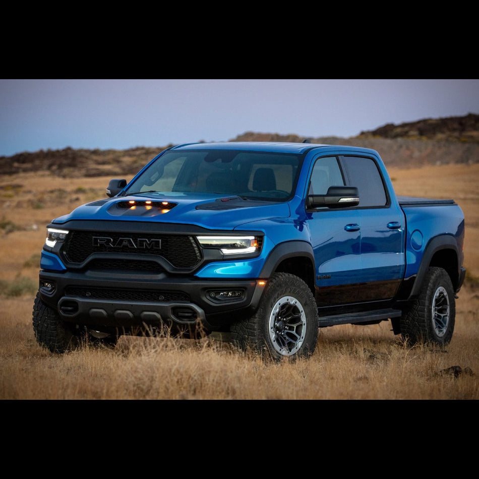 Blue Dodge Ram TRX in a field of long grass