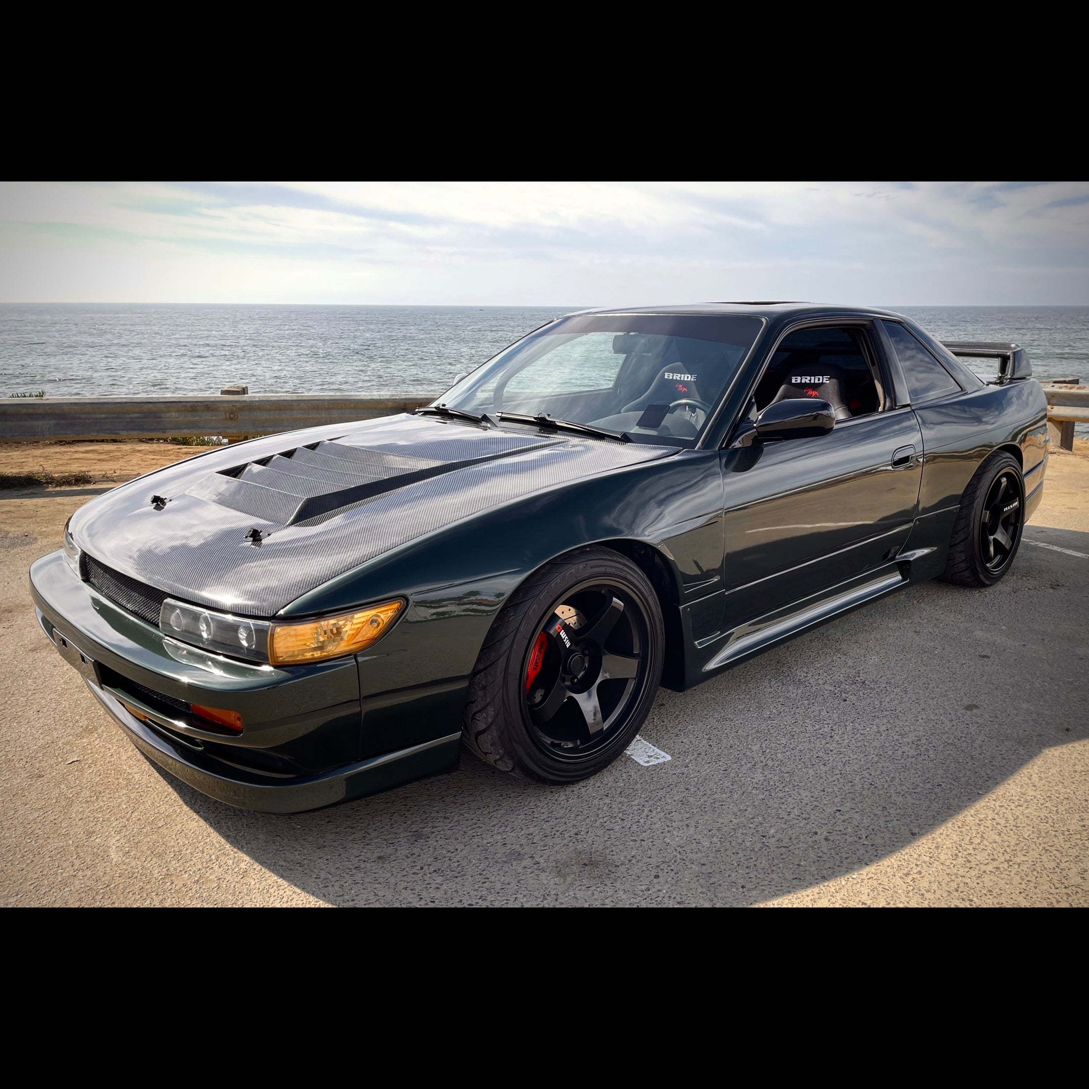 Green Nissan S13 Silvia 240sx at the ocean