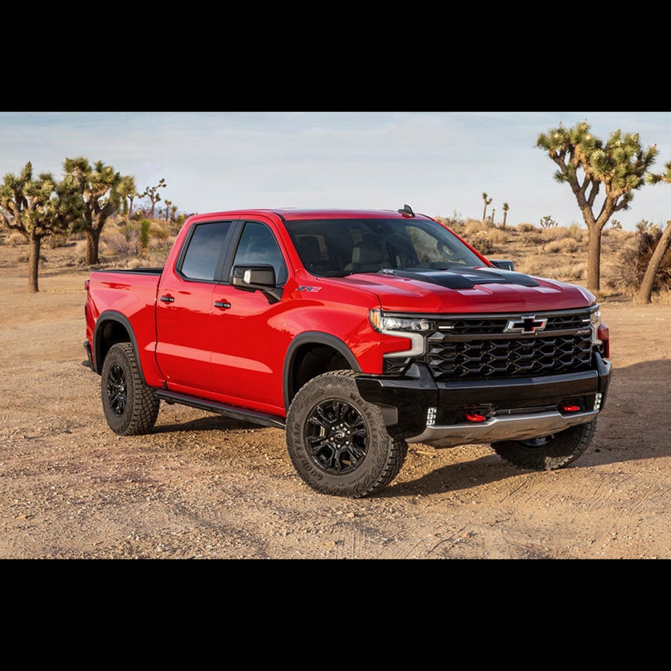 Red Chevrolet Silverado 1500 zr2 on a dirt road
