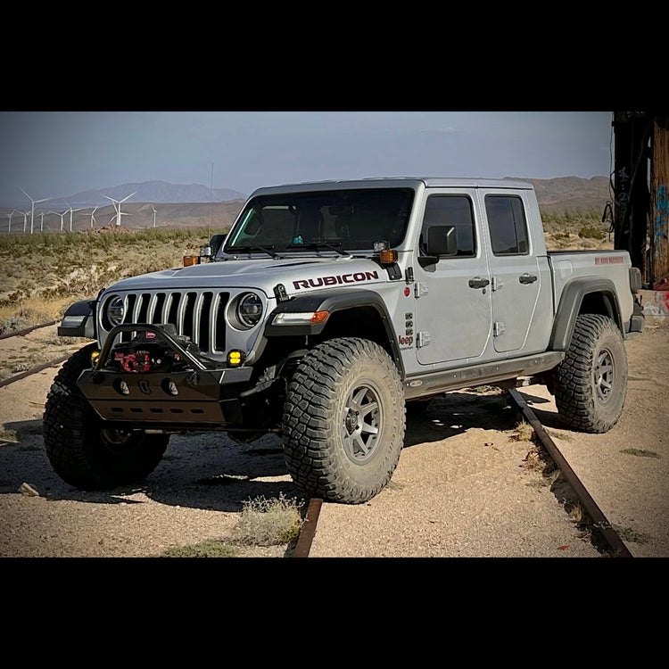Jeep Gladiator in silver off road on train tracks in desert