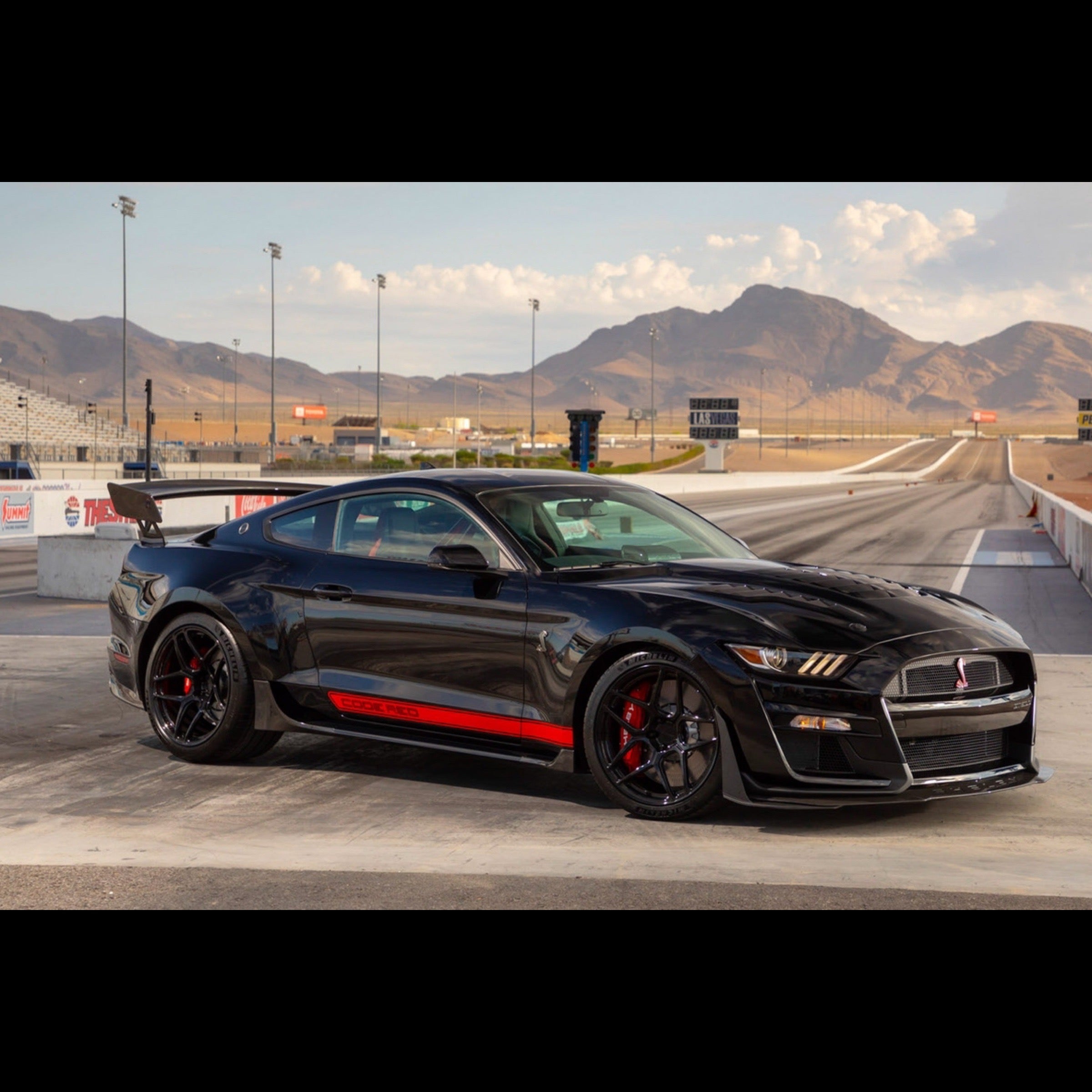 Black Mustang gt500 code red at a drag strip